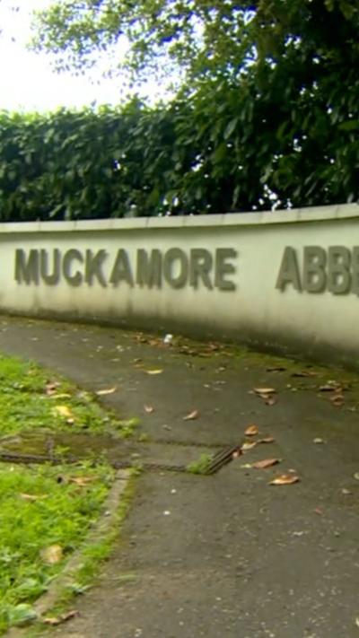 A wall with Muckamore in silver lettering on it. 