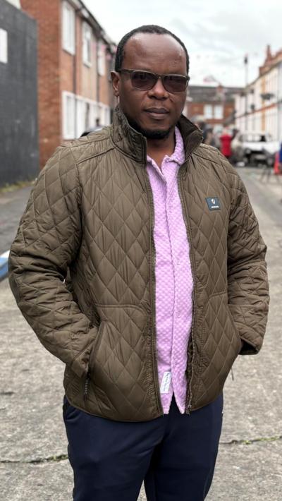 Anselme Shima, who lives close to Lendrick Street in east Belfast, stands out on a street.