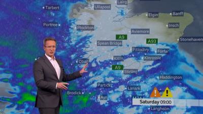 BBC Scotland weather presenter Christopher Blanchett in front of a weather map of Scotland showing snow warnings.