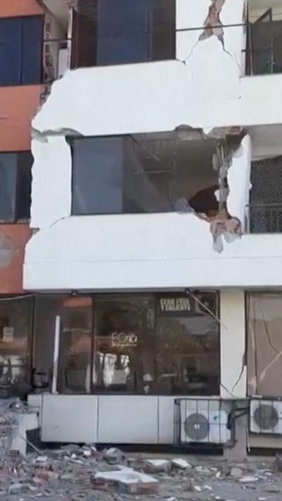 A collapsing building facade after it was struck by an earthquake.