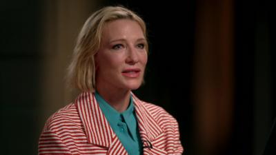 Cate Blanchett wearing a red and while striped jacket 