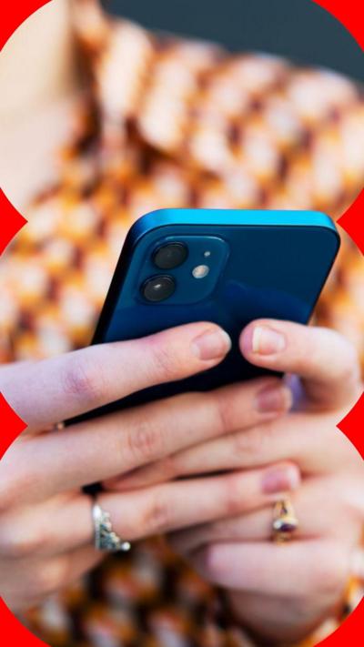 A woman holds a blue smartphone
