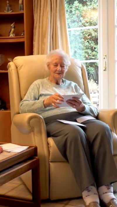 Woman in armchair reading post