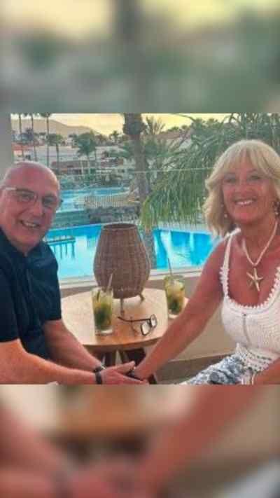 A couple sitting at a table on holiday