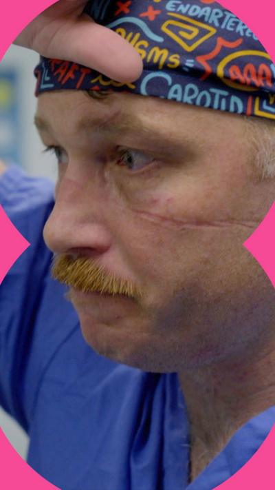 Surgeon with moustache places hand on head
