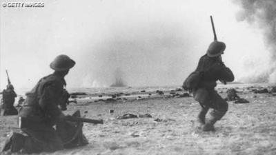 British soldiers fight a rearguard action during the evacuation at Dunkirk, shooting rifles at attacking aircraft.