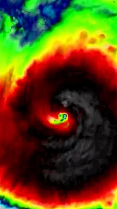 A colourised satellite image showing a big black and red swirl depicting the hurricane