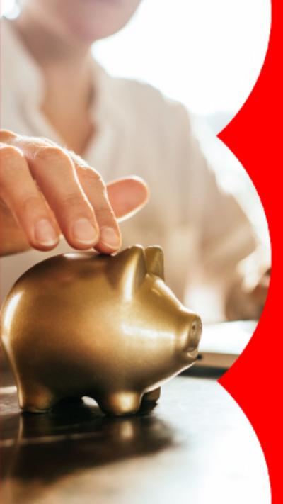 A woman places money in a gold piggy bank