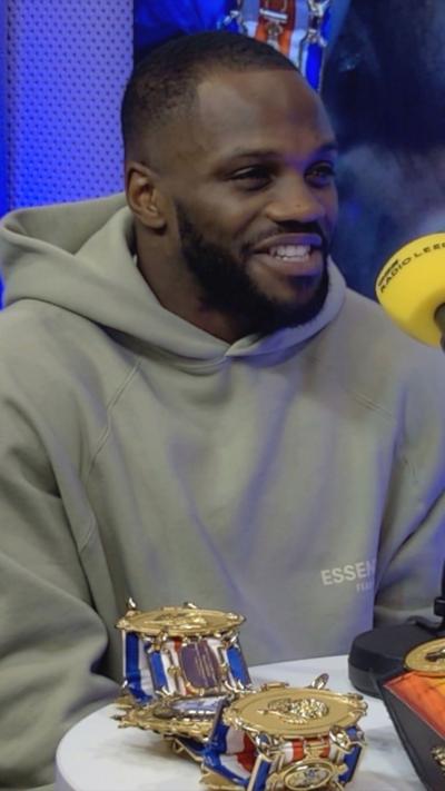Boxer Ishmael Davis in a BBC Radio Leeds studio with the Commonwealth and British boxing belts in front of him