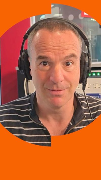 Martin Lewis in podcast room wearing headphones