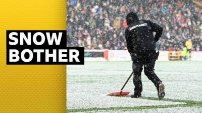 Snow being swept away at Pittodrie