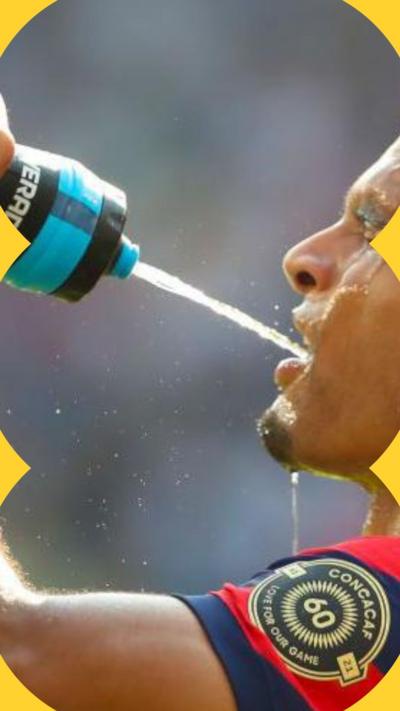 A man squirts water into his mouth from a water bottle