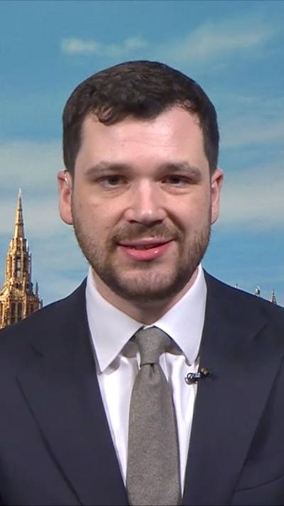 Henry Zeffman in a dark suit and grey tie
