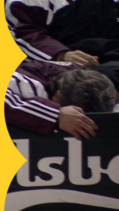 Kevin Keegan is slumped over a hoarding, while a smiling Stan Collymore celebrates the winner