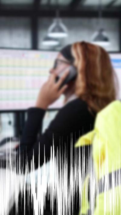 Female police officer on the phone in control room