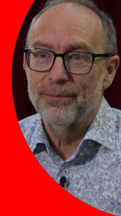 Jimmy Wales wearing a blue shirt 