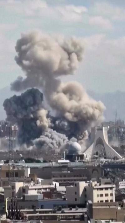 A huge plume of smoke behind Iran's Azadi Tower