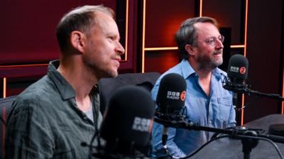 Robert Webb and David Mitchell sit in a Radio 2 studio, in front of microphones