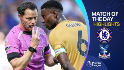 Referee Darren England with Crystal Palace captain Marc Guehi