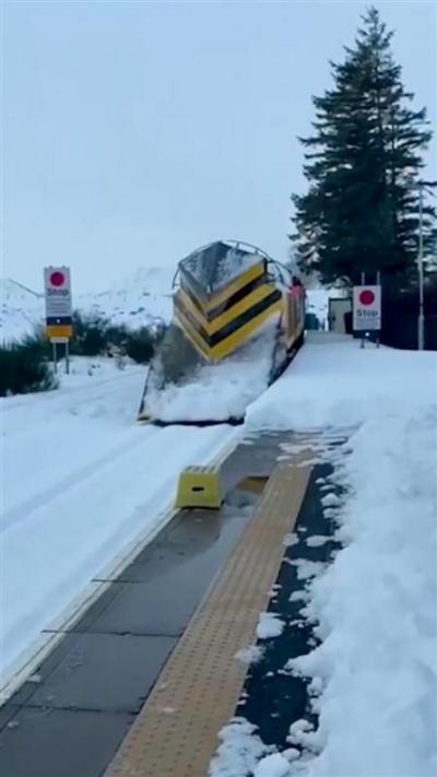 A snow plough on a snowy railway line