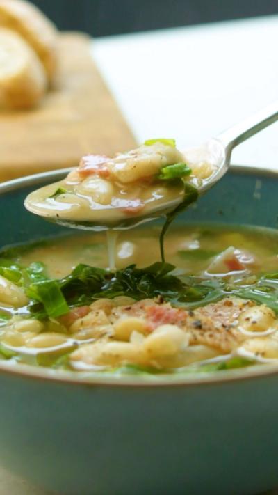 White bean and bacon soup in a green bowl.