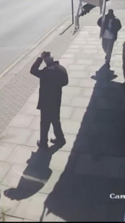 A man appears to put his arm out while another man is seen lunging in his direction