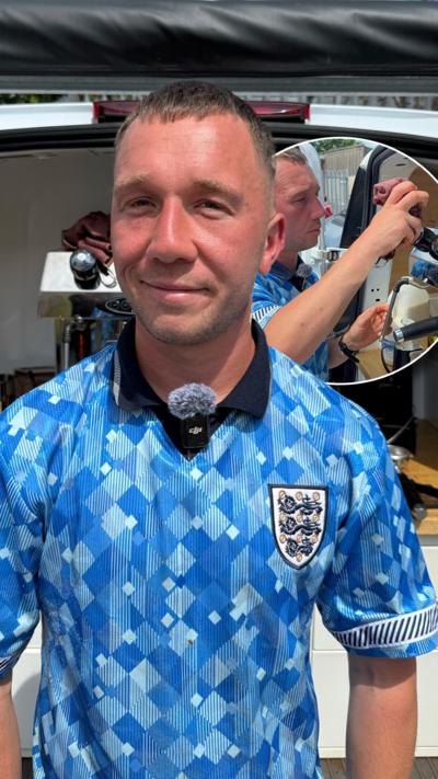 A coffee man in a blue England kit in front of his coffee van