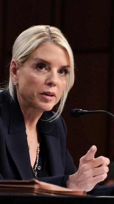 Pam Bondi points while sitting during a Congressional hearing.