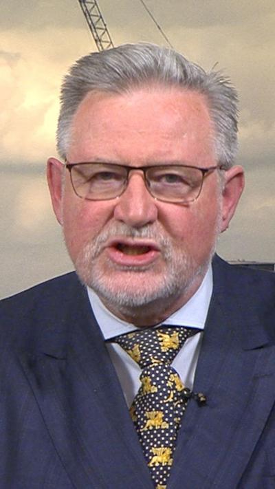 Barry Gardiner wears a blue suit
