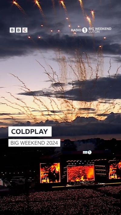 Coldplay at Radio 1 Big Weekend festival. The stage is lit up with colour.