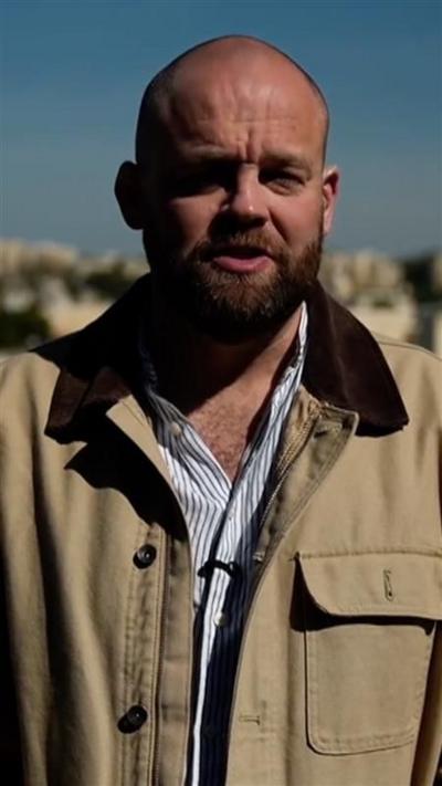 James Waterhouse wearing a shirt and a jacket