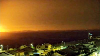 Orange light from explosion seen over Gaza skyline