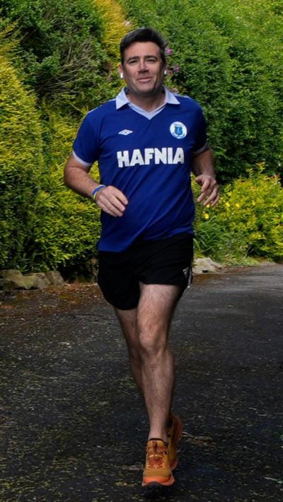 Andy Burnham runs in a vintage Everton top 