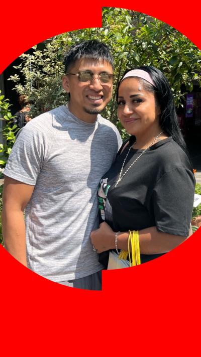 A couple posing by a tree
