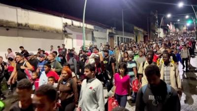 Crowds of people walking streets at night