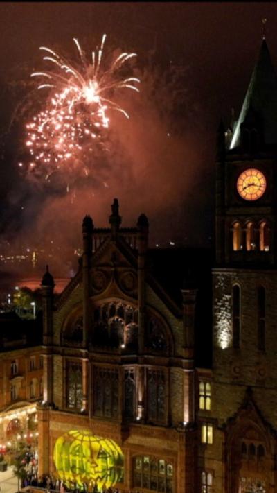 Fireworks going off over the Guildhall in Derry.