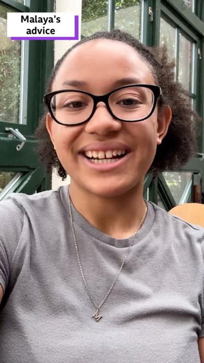 Malaya, a smiley teenager, in a cafe. 