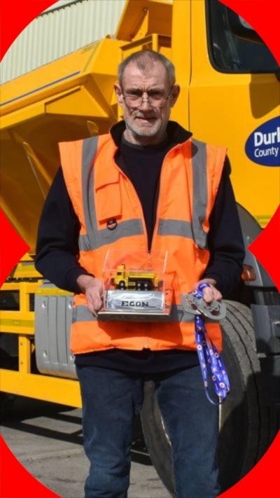 Gary Lawson pictured holding his awards for being named Gritter Driver of the Year.