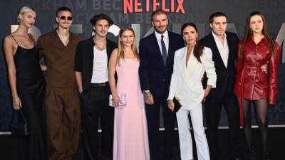 David and Victoria Beckham with their children, and their partners, at a Netflix red carpet event.