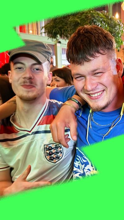 Two young men watching football at the pub, Ollie and Joey, with arms around each other