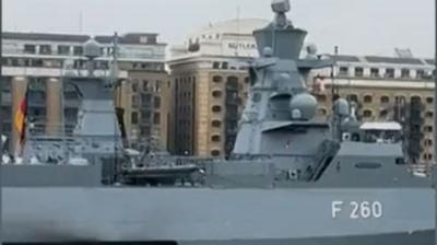 The German military ship, which is large and grey and has the number F260 on the side in white