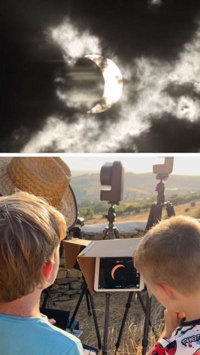 Two boys looking at eclipse image