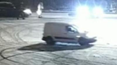 A white van doing donuts in the snow on a Peterborough car park