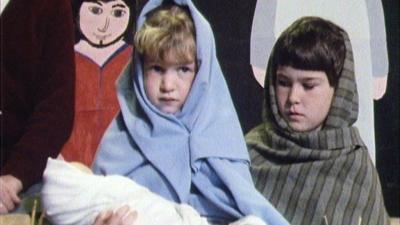 Children dressed as Mary and Joseph holding a baby doll Jesus