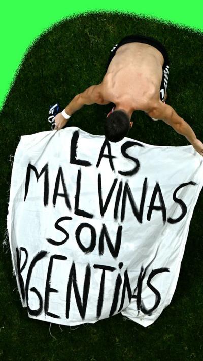 Argentina players hold a Falklands flag after their World cup semi-final against England
