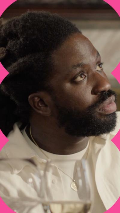 Kwabena looks at the waiter in shock