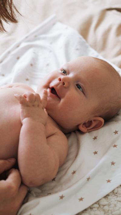 Baby laying on bed
