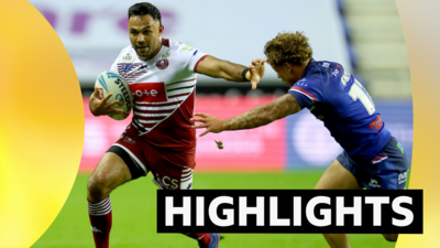 Bevan French of Wigan Warriors and Harvey Smith of Wakefield Trinity in action