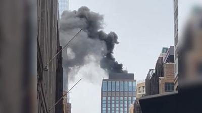 Smoke is seen from the top of a building.