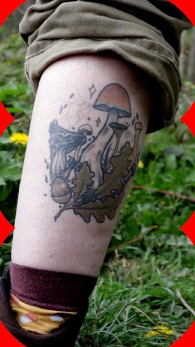 A bundle of mushrooms tattooed on to a leg